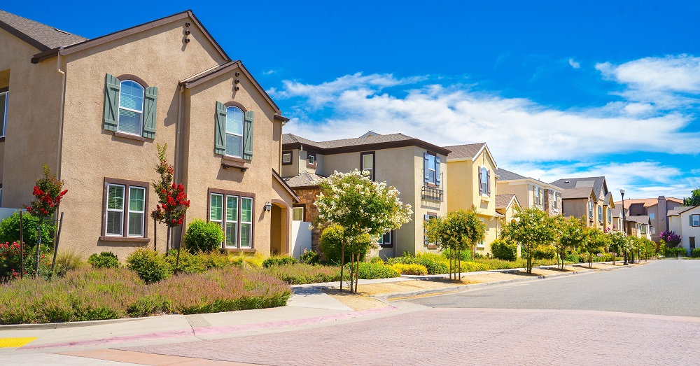 Modern Irvine, California townhouse exterior showing clean architecture and blue skies